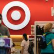 Image of shoppers inside a Target store with the Target logo prominently displayed in the background. Image of shoppers inside a Target store with the Target logo prominently displayed in the background.