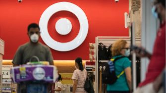 Image of shoppers inside a Target store with the Target logo prominently displayed in the background.