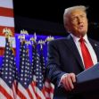 Donald Trump speaking at a podium with American flags in the background. Donald Trump speaking at a podium with American flags in the background.