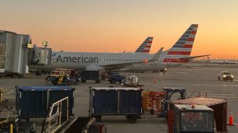 American Airlines planes at an airport during sunset.