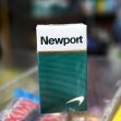 A pack of Newport menthol cigarettes displayed on a store counter. A pack of Newport menthol cigarettes displayed on a store counter.