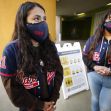 Garfield High School student leaders Sarahi Bahena, left, and Edith Ramirez, both seniors, wait to greet freshmen arriving for their first time on the East L.A. campus in April. School officials are planning to fully reopen schools in the fall.(Al Seib / Los Angeles Times)