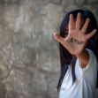 A child holds out their hand with the word "STOP" written on it, symbolizing a call to end forced labor and human trafficking. A child holds out their hand with the word "STOP" written on it, symbolizing a call to end forced labor and human trafficking.