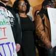 Demonstrators hold signs advocating for the legalization of marijuana and community reinvestment in New York. Demonstrators hold signs advocating for the legalization of marijuana and community reinvestment in New York.