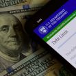 Image of a smartphone displaying information from the U.S. Department of the Treasury about the debt limit, with a backdrop of U.S. currency featuring Benjamin Franklin. Image of a smartphone displaying information from the U.S. Department of the Treasury about the debt limit, with a backdrop of U.S. currency featuring Benjamin Franklin.