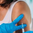 A healthcare professional administering a vaccination to a patient's arm. A healthcare professional administering a vaccination to a patient's arm.