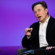 Elon Musk speaking during an event, with a glass of water on a table beside him. Elon Musk speaking during an event, with a glass of water on a table beside him.
