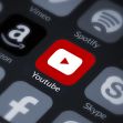 YouTube app icon surrounded by various social media and streaming service icons. YouTube app icon surrounded by various social media and streaming service icons.