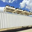 A Bitcoin mining data center with large cooling units on top of a shipping container. A Bitcoin mining data center with large cooling units on top of a shipping container.