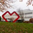 Exterior view of a CVS building featuring a large red heart sculpture in front, surrounded by grass and trees. Exterior view of a CVS building featuring a large red heart sculpture in front, surrounded by grass and trees.