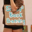 A person holding a cardboard sign that reads "Stop Book Banning." A person holding a cardboard sign that reads "Stop Book Banning."