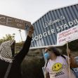 Protesters holding signs outside Dodger Stadium advocating against ICE presence and expressing anti-Trump sentiments. Protesters holding signs outside Dodger Stadium advocating against ICE presence and expressing anti-Trump sentiments.