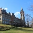 Exterior view of a historic building at Lehigh University on a clear day with blue sky and trees in the foreground. Exterior view of a historic building at Lehigh University on a clear day with blue sky and trees in the foreground.