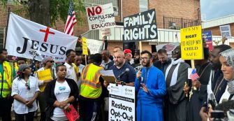 Protesters at a rally opposing educational policies on transgender issues, holding signs related to parental rights and educational choices.