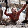 Participants struggling in muddy conditions during a Tough Mudder race. Participants struggling in muddy conditions during a Tough Mudder race.