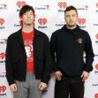 Image of the musical duo Twenty One Pilots at an event, standing in front of a promotional backdrop. Image of the musical duo Twenty One Pilots at an event, standing in front of a promotional backdrop.
