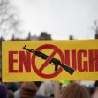 Protest sign with a crossed-out assault rifle and the word "ENOUGH" during a demonstration against gun violence. Protest sign with a crossed-out assault rifle and the word "ENOUGH" during a demonstration against gun violence.