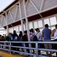 A line of people waiting at a border checkpoint in the United States. A line of people waiting at a border checkpoint in the United States.