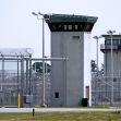 View of prison towers surrounded by fencing. View of prison towers surrounded by fencing.