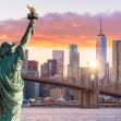 The Statue of Liberty with the New York City skyline in the background during sunset. The Statue of Liberty with the New York City skyline in the background during sunset.