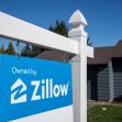 Sign with Zillow branding displayed outside a residential property. Sign with Zillow branding displayed outside a residential property.