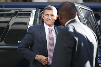 General Michael Flynn arriving from a vehicle during a public appearance.