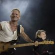 Sting performing on stage with an accompanying musician. Sting performing on stage with an accompanying musician.