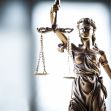 A bronze statue of Lady Justice holding scales and a sword, symbolizing the legal system and justice. A bronze statue of Lady Justice holding scales and a sword, symbolizing the legal system and justice.