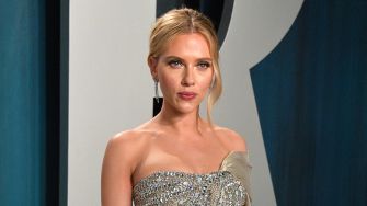 Scarlett Johansson at an event, wearing an elegant gown and posing for the camera.