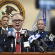 A press conference regarding the indictment of law enforcement officials and a business owner for U-Visa fraud, with a U.S. Attorney speaking surrounded by law enforcement representatives. A press conference regarding the indictment of law enforcement officials and a business owner for U-Visa fraud, with a U.S. Attorney speaking surrounded by law enforcement representatives.