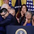 A moment of celebration as President Joe Biden embraces an individual during an announcement regarding new immigration policies, surrounded by supporters. A moment of celebration as President Joe Biden embraces an individual during an announcement regarding new immigration policies, surrounded by supporters.