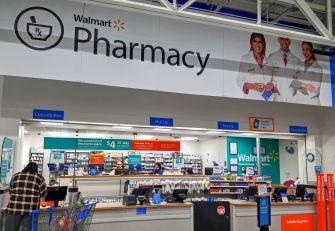 Interior view of a Walmart pharmacy, showing the pharmacy counter and signage.