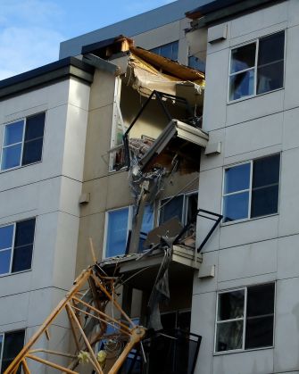 Damage to an apartment building caused by a crane collapse.