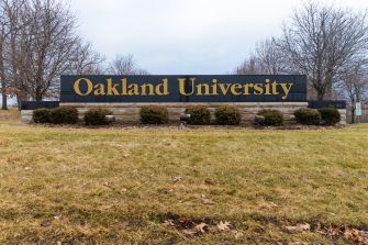 Signage for Oakland University, featuring the university name prominently displayed.