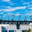 Exterior view of the Blizzard Entertainment headquarters under a blue sky with clouds. Exterior view of the Blizzard Entertainment headquarters under a blue sky with clouds.