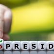 A hand rearranging letter blocks to change "OLD PRESIDENT" to "NEW PRESIDENT." A hand rearranging letter blocks to change "OLD PRESIDENT" to "NEW PRESIDENT."