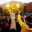Crowd enjoying a music festival with colorful stage lights and vibrant atmosphere. Crowd enjoying a music festival with colorful stage lights and vibrant atmosphere.