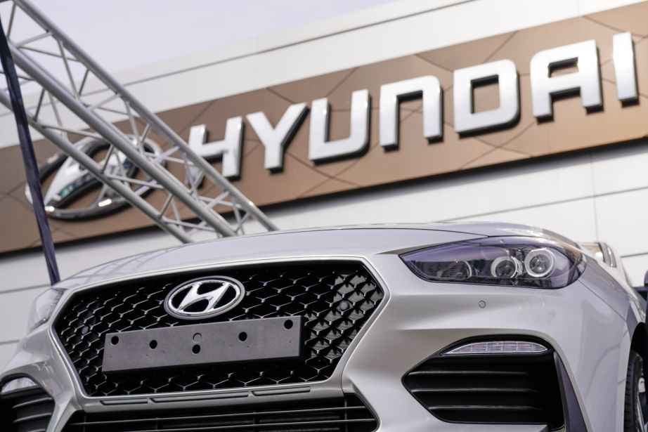 Hyundai logo sign i30 on front grill of grey new car vehicle