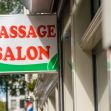 Sign for a massage salon, indicating the business type and services offered. Sign for a massage salon, indicating the business type and services offered.