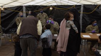Afghan refugees receiving assistance at a processing center after their arrival in the U.S.