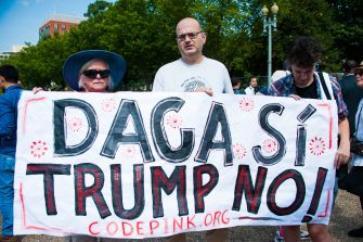 Activists holding a banner that reads "DACA SÍ TRUMP NO!" during a demonstration advocating for the DACA program.
