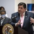Governor J.B. Pritzker speaking at a press event regarding Illinois' efforts to end federal immigration detention programs, with a person in the background. Governor J.B. Pritzker speaking at a press event regarding Illinois' efforts to end federal immigration detention programs, with a person in the background.