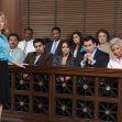 A courtroom scene showing a juror pointing while other jurors look on attentively. A courtroom scene showing a juror pointing while other jurors look on attentively.
