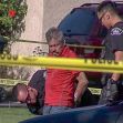 A man in handcuffs is being detained by police at the scene of an accident involving a six-year-old girl. A man in handcuffs is being detained by police at the scene of an accident involving a six-year-old girl.