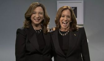 Kamala Harris and Maya Rudolph during a sketch on Saturday Night Live, with both dressed in black and smiling at the camera.