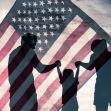 Silhouette of a family holding hands in front of an American flag. Silhouette of a family holding hands in front of an American flag.