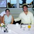 Scott Peterson and Laci Peterson at a dining table, smiling, with drinks and food in front of them. Scott Peterson and Laci Peterson at a dining table, smiling, with drinks and food in front of them.
