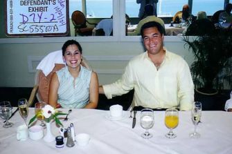 Scott Peterson and Laci Peterson at a dining table, smiling, with drinks and food in front of them.