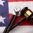 A gavel and a stethoscope on an American flag background, symbolizing a legal decision related to healthcare. A gavel and a stethoscope on an American flag background, symbolizing a legal decision related to healthcare.