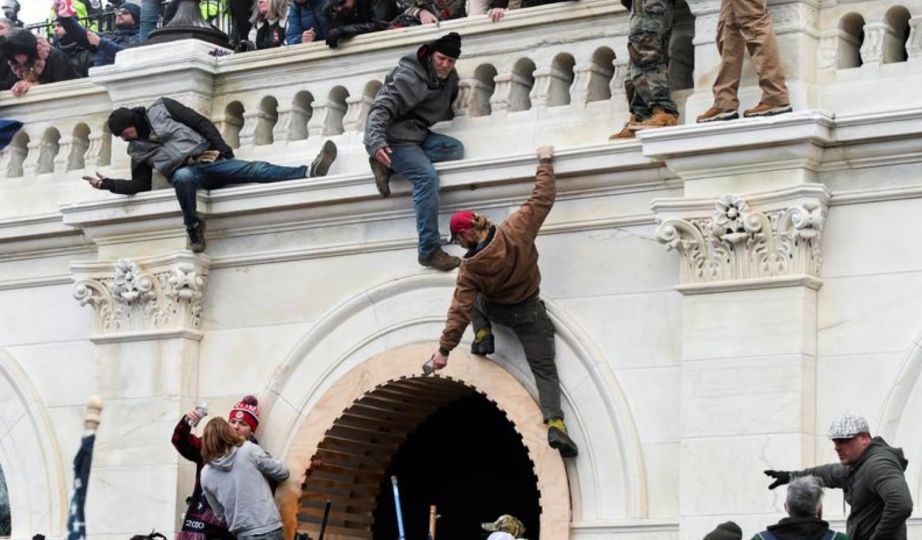 Supporters of U.S. President Donald Trump climb on walls at the U.S. Capitol during a protest against the certification of the 2020 U.S. presidential election results by the U.S. Congress, in Washington, U.S., January 6, 2021. REUTERS/Stephanie Keith/File Photo